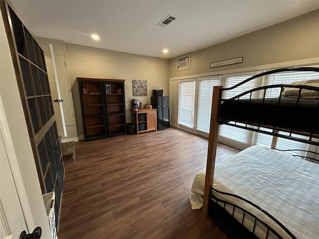 bedroom with black refrigerator and dark hardwood / wood-style flooring