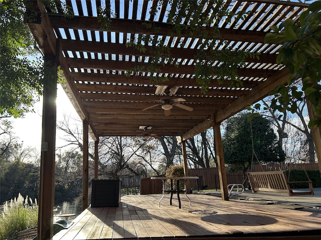 wooden deck with ceiling fan and a pergola