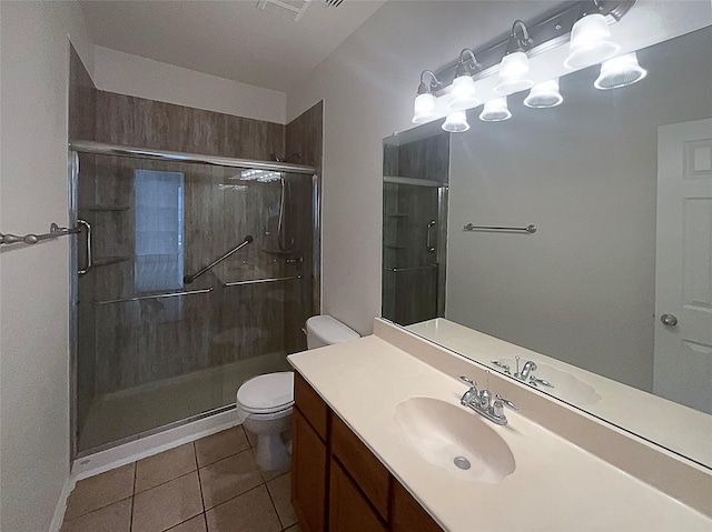 bathroom with vanity, toilet, an enclosed shower, and tile patterned flooring