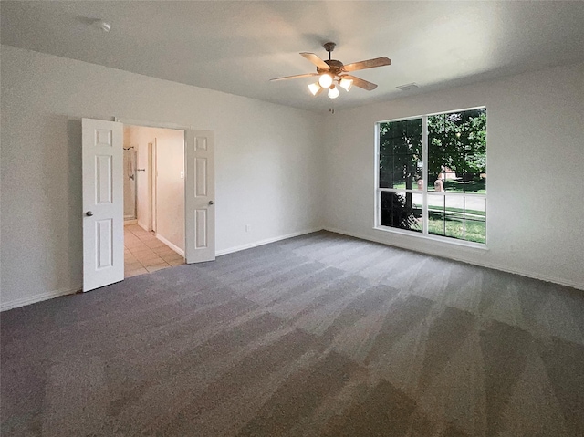 empty room featuring light colored carpet and ceiling fan