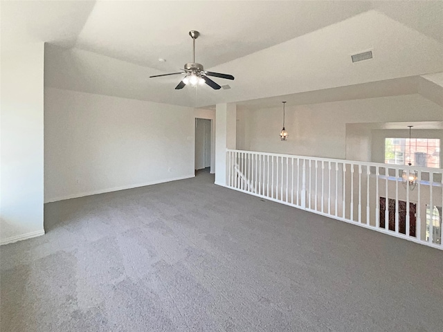 unfurnished room featuring dark carpet, ceiling fan, and vaulted ceiling