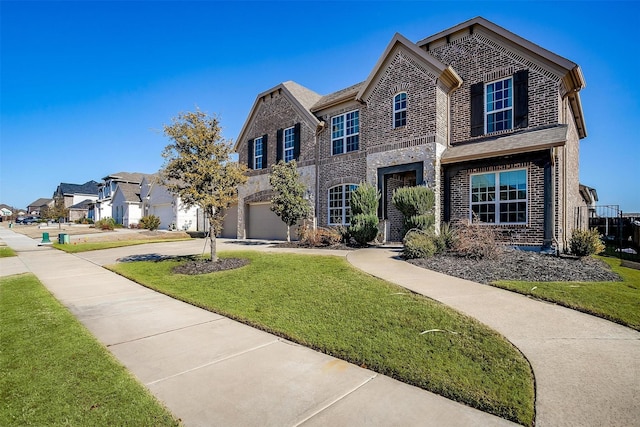 front of property with a front yard and a garage