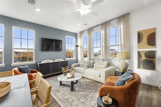 living room with ceiling fan and dark hardwood / wood-style floors