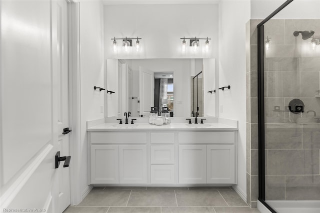 bathroom featuring an enclosed shower, tile patterned floors, and vanity