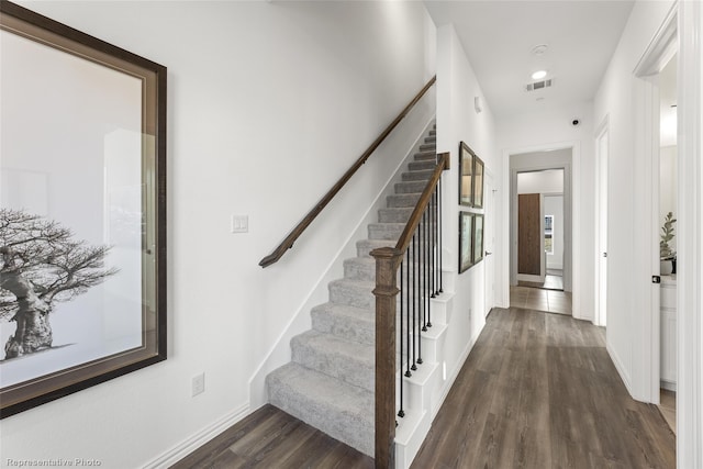 stairway featuring hardwood / wood-style floors