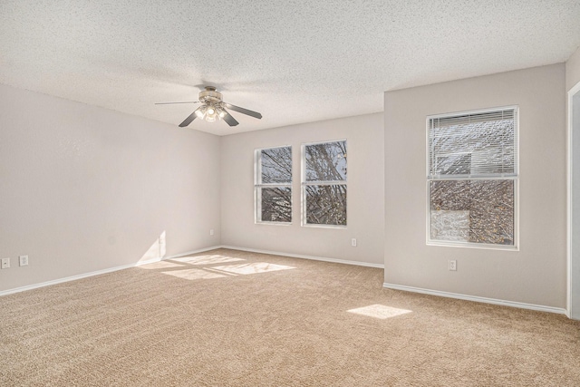 unfurnished room featuring a textured ceiling, light colored carpet, and ceiling fan