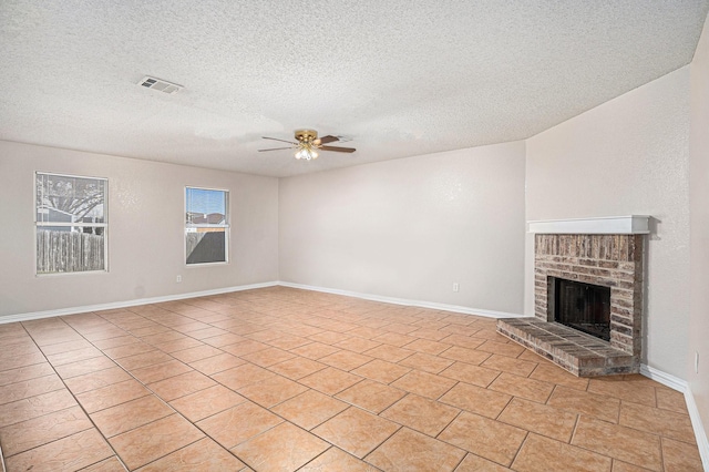 unfurnished living room with ceiling fan, light tile patterned flooring, a textured ceiling, and a fireplace