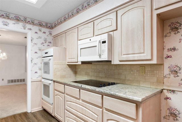 kitchen featuring white appliances, light brown cabinetry, tasteful backsplash, dark hardwood / wood-style flooring, and light stone counters