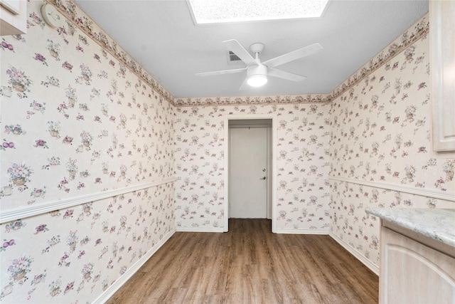 unfurnished room with ceiling fan and hardwood / wood-style floors