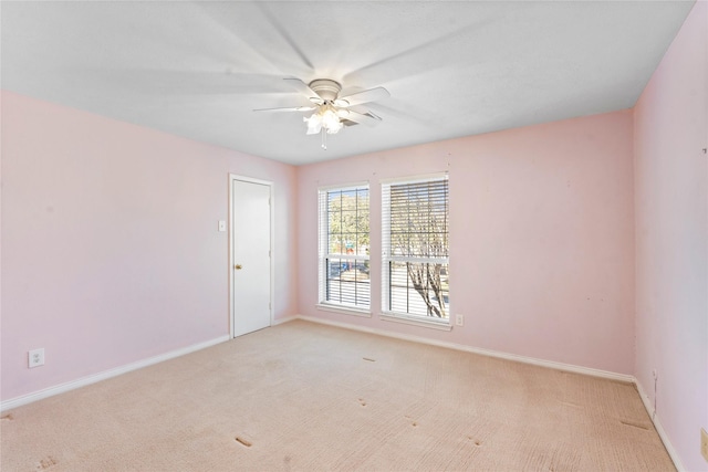 carpeted spare room featuring ceiling fan