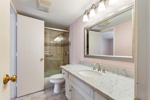 full bathroom featuring bath / shower combo with glass door, toilet, and vanity