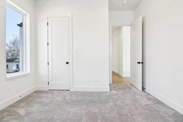 unfurnished bedroom featuring light colored carpet