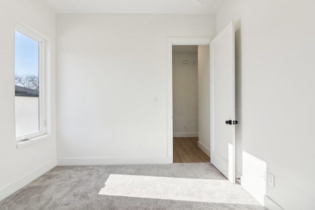 spare room with light colored carpet