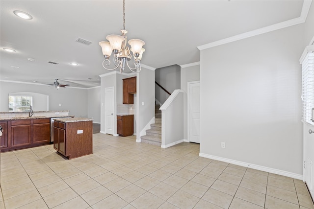 kitchen with decorative light fixtures, crown molding, light tile patterned floors, visible vents, and a kitchen island