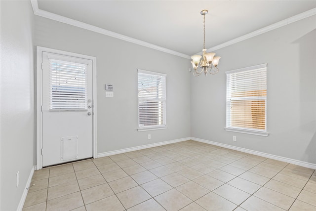 unfurnished room featuring a chandelier, crown molding, and baseboards