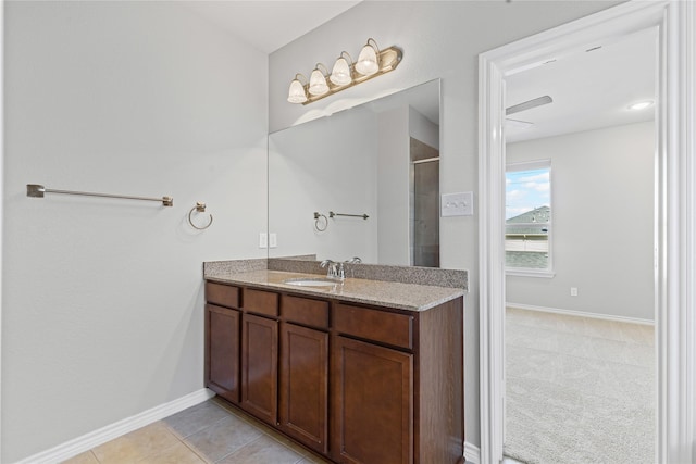 full bathroom featuring an enclosed shower, vanity, baseboards, and tile patterned floors