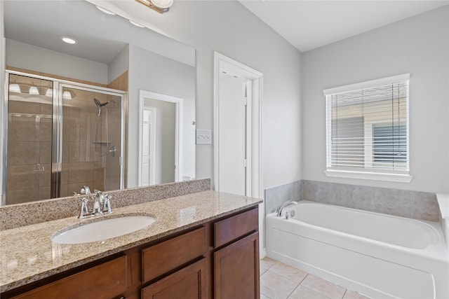 full bath featuring a bath, a shower stall, vanity, and tile patterned floors