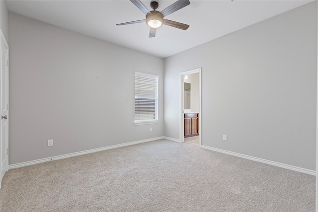 unfurnished room featuring ceiling fan, baseboards, and light colored carpet