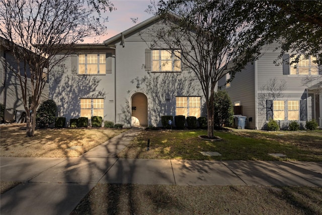 view of front of property with brick siding and a front yard