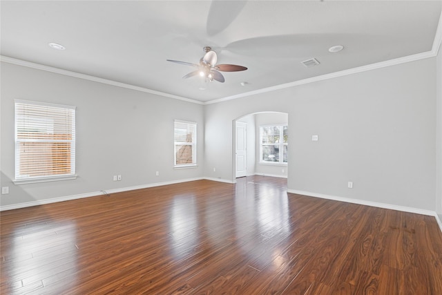 empty room featuring visible vents, arched walkways, baseboards, dark wood-style floors, and ceiling fan