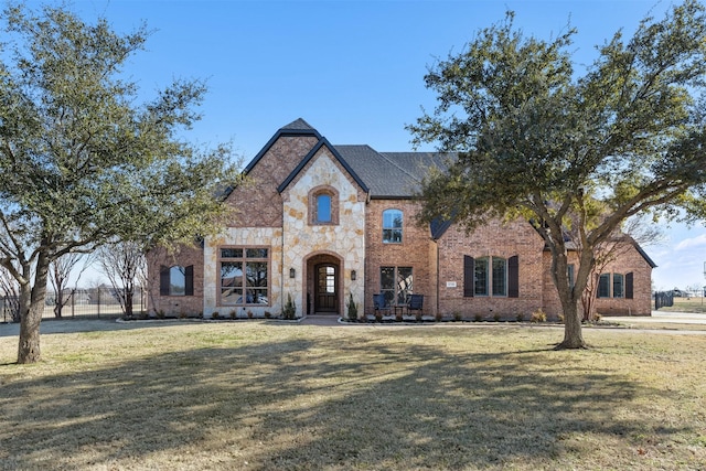 french provincial home featuring a front lawn