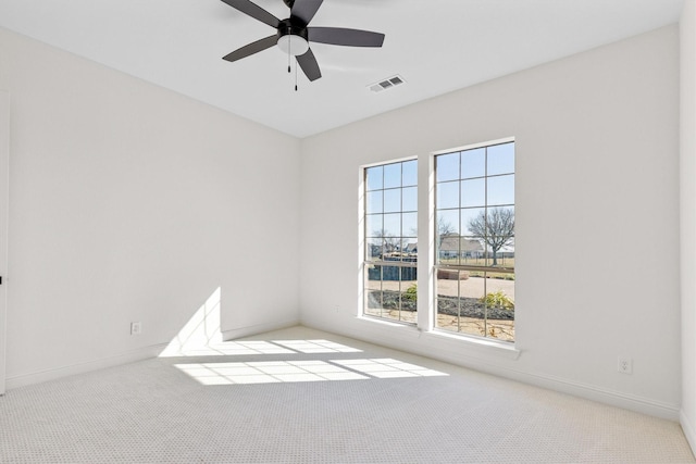 carpeted empty room featuring ceiling fan