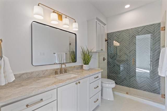 bathroom featuring vanity, a shower with shower door, tile patterned floors, and toilet