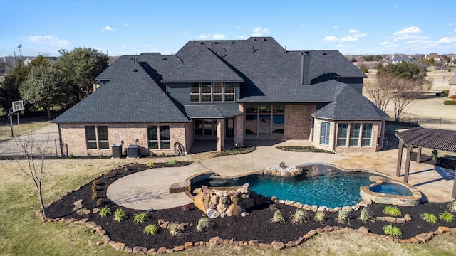 view of pool with a patio and an in ground hot tub