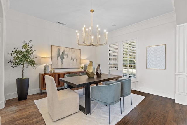 dining room with an inviting chandelier, crown molding, and dark wood-type flooring