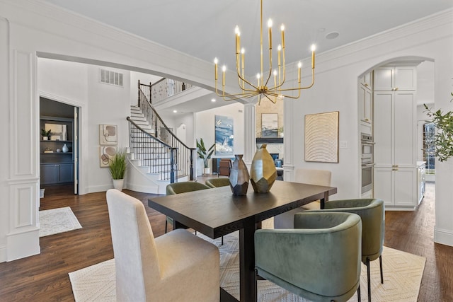 dining area with ornamental molding and dark hardwood / wood-style flooring