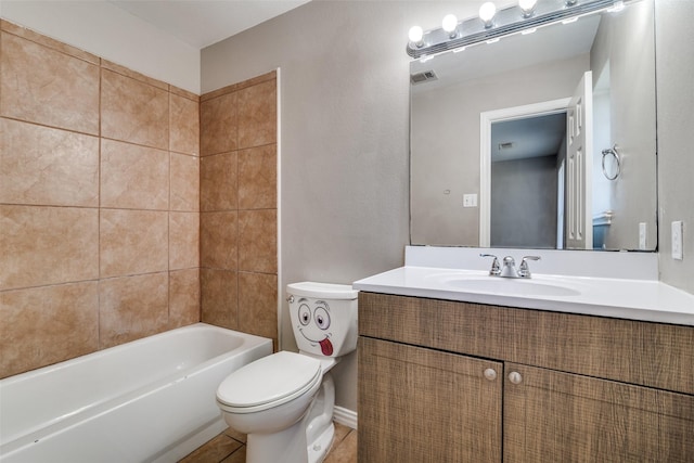 full bathroom featuring vanity, toilet, tile patterned floors, and tiled shower / bath combo