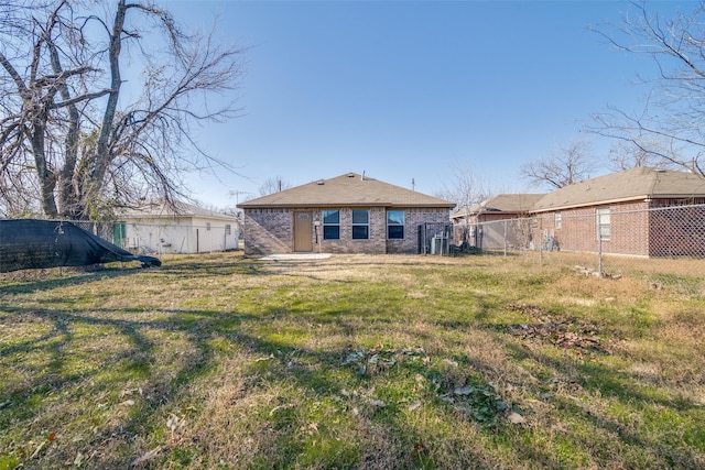 rear view of house featuring a lawn