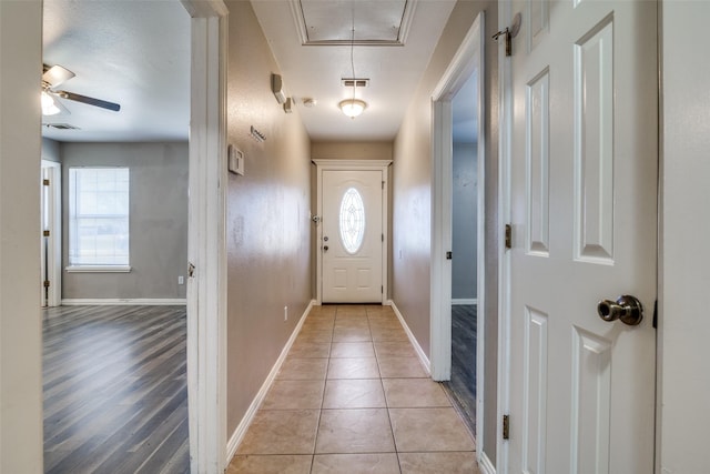 entryway with light tile patterned floors and ceiling fan