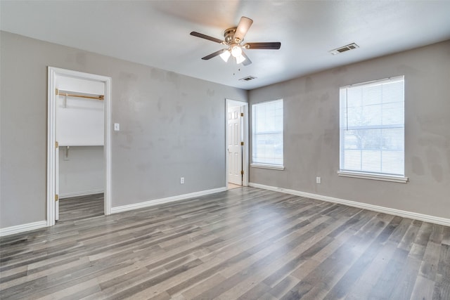 empty room with hardwood / wood-style flooring and ceiling fan