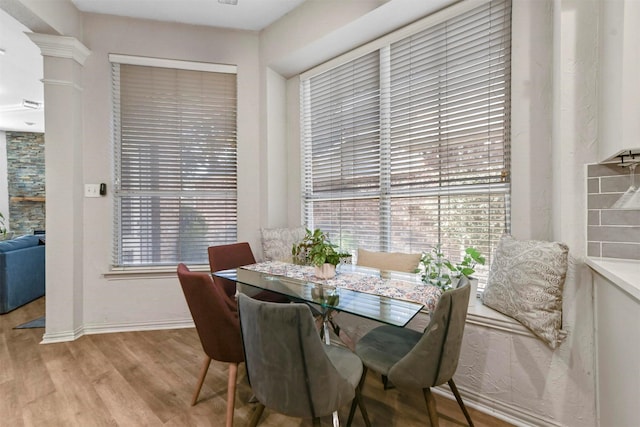 dining space featuring light wood-type flooring and a healthy amount of sunlight