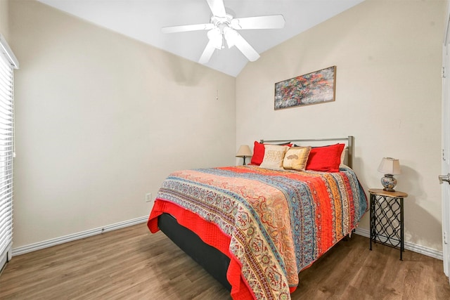 bedroom featuring ceiling fan, dark hardwood / wood-style flooring, and lofted ceiling