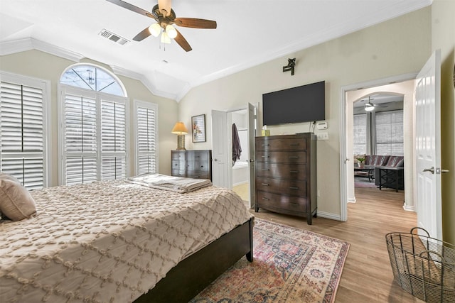 bedroom with ceiling fan, lofted ceiling, crown molding, and light wood-type flooring