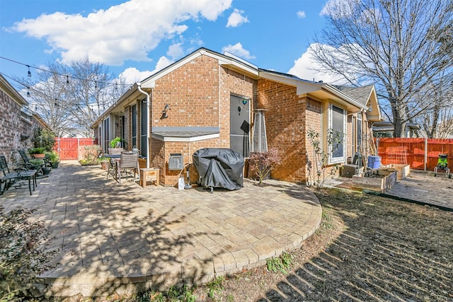 back of property with a patio