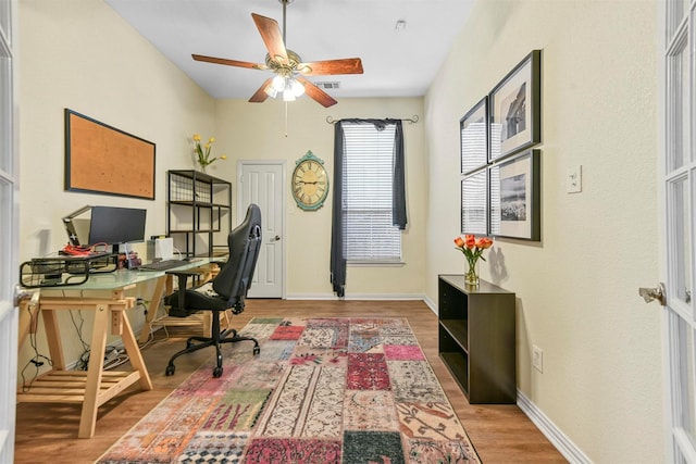 home office with hardwood / wood-style floors and ceiling fan