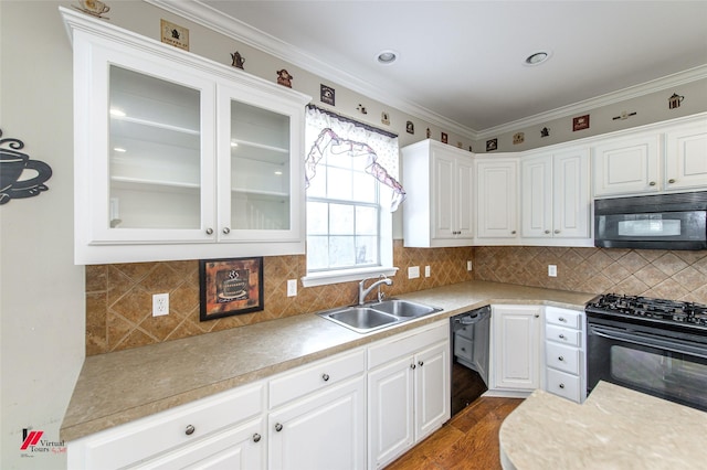 kitchen with black appliances, white cabinets, sink, dark wood-type flooring, and backsplash