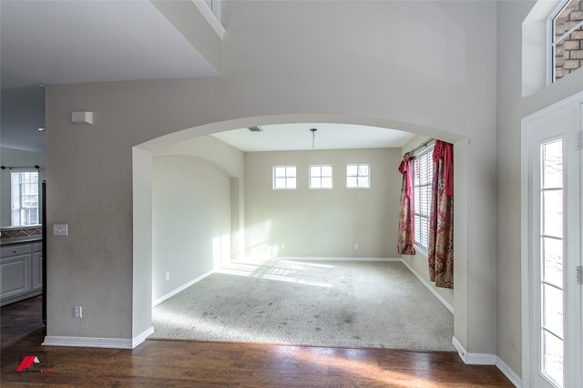 entryway with plenty of natural light and dark hardwood / wood-style floors