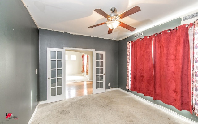 carpeted empty room featuring ceiling fan and french doors