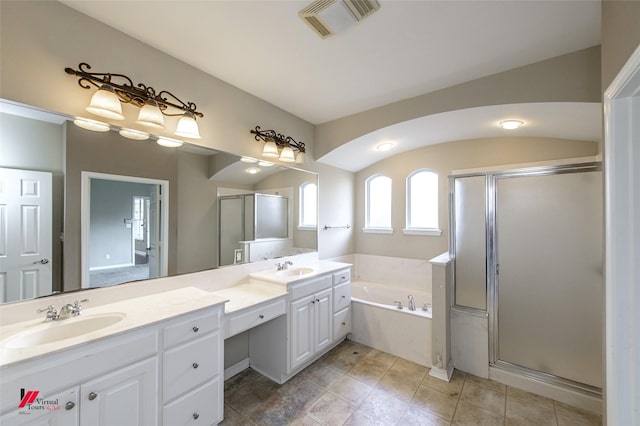 bathroom featuring vanity and independent shower and bath