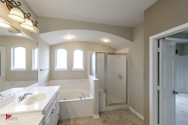 bathroom featuring tile patterned flooring, vanity, and plus walk in shower