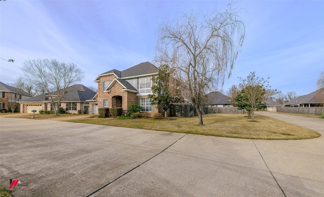 view of property with a garage and a front lawn