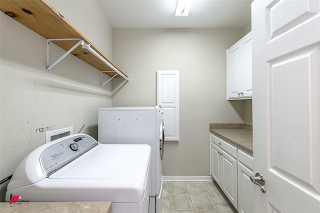 clothes washing area featuring cabinets and washing machine and clothes dryer