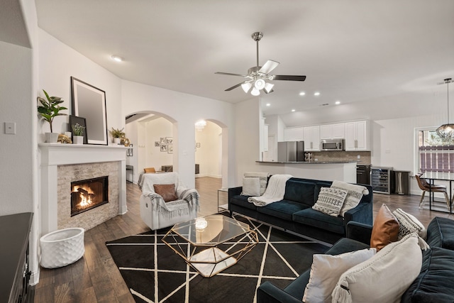 living room featuring dark hardwood / wood-style floors, beverage cooler, and ceiling fan