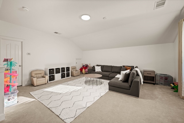 carpeted living room with vaulted ceiling