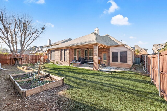 back of house with a patio, a yard, and central AC