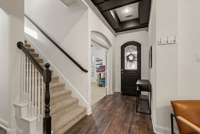 foyer with coffered ceiling and dark hardwood / wood-style flooring